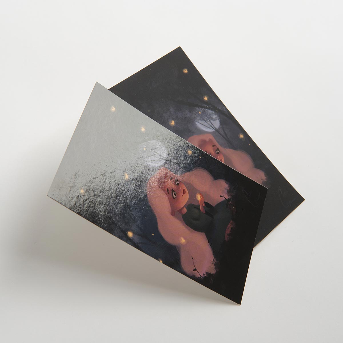 Two custom postcards overlapping each other and printed with Soft Touch laminate.